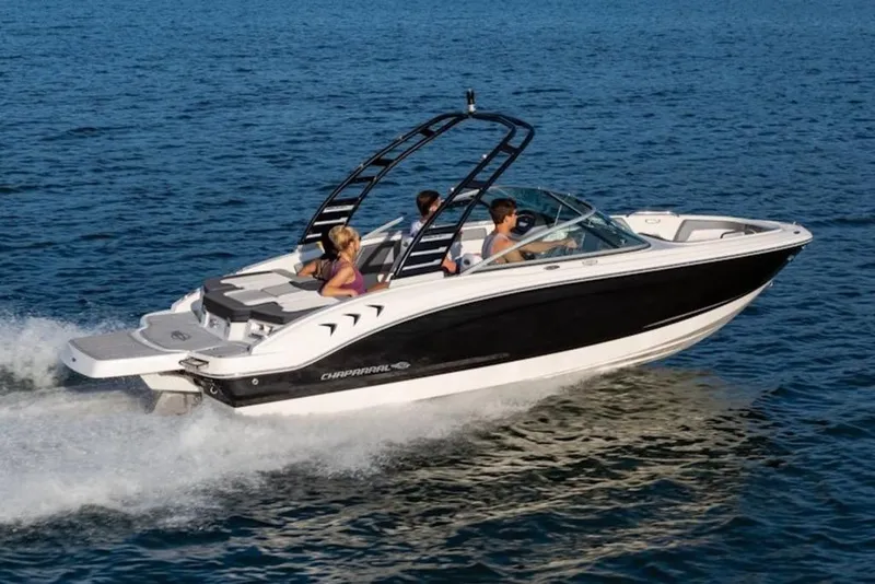 The Image of 2026 Chaparral 21 SSi boat cruising on open water with passengers. - 1