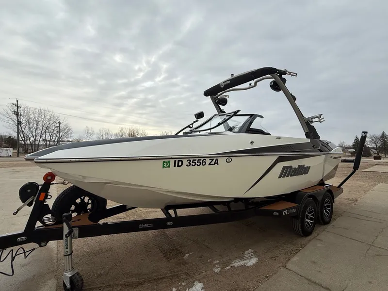 Slide: The Image of 2021 Malibu Wakesetter 21 MLX on trailer, cloudy sky. - 2