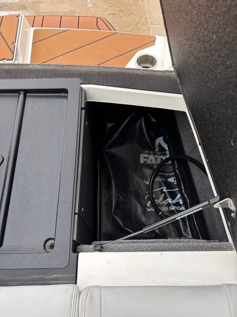 Slide: The Image of 2021 Malibu Wakesetter 21 MLX storage compartment with ballast bag. - 35