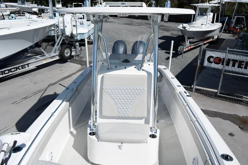 Slide: The Image of 2023 Contender 24 Sport boat with sleek design and modern features, docked at a marina. - 12