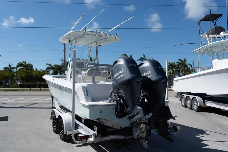 Slide: The Image of 2023 Contender 24 Sport boat with dual Yamaha engines on trailer, sunny day. - 3