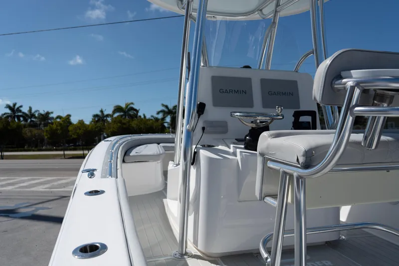 Slide: The Image of 2023 Contender 24 Sport boat interior with Garmin navigation, sleek design, and comfortable seating. - 7