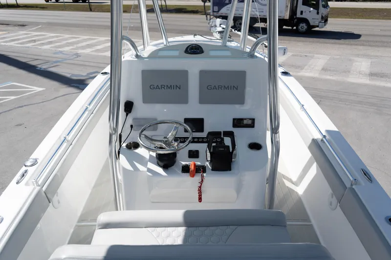 Slide: The Image of 2023 Contender 24 Sport boat console with Garmin navigation system and steering wheel. - 8