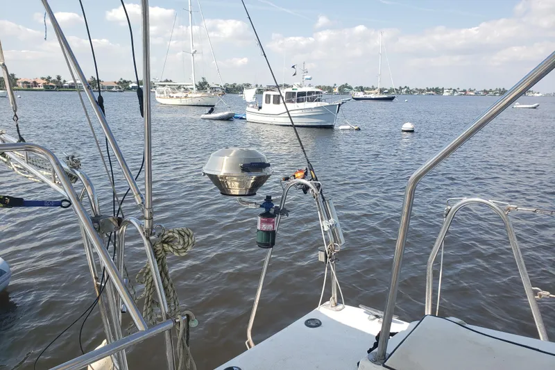 Slide: The Image of Sailboat view from Gemini 105 MC, 2006 model, anchored in a serene harbor. - 14