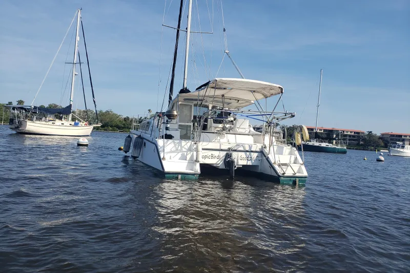 Slide: The Image of 2006 Gemini 105 MC catamaran anchored on calm water, surrounded by other sailboats. - 15