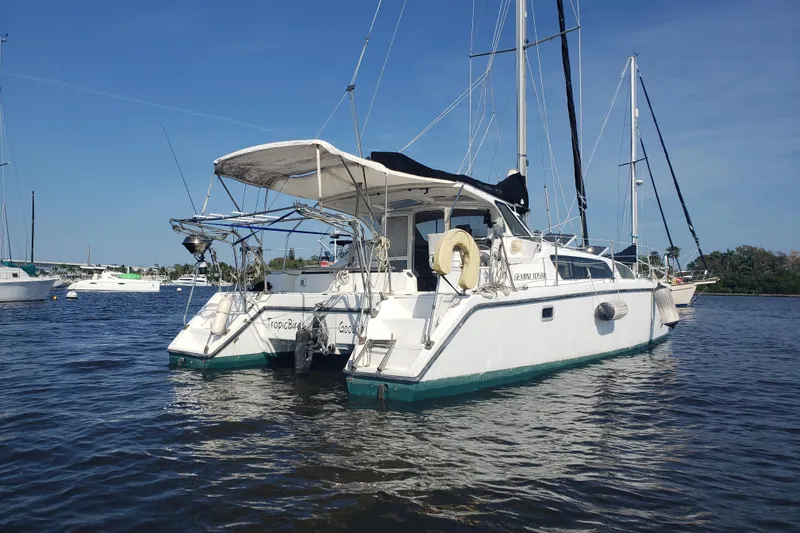 Slide: The Image of 2006 Gemini 105 MC catamaran anchored on calm water under clear blue sky. - 16