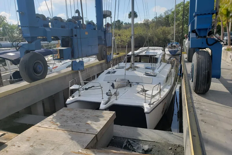 Slide: The Image of Catamaran Gemini 105 MC 2006 in dry dock with blue hoist equipment. - 17