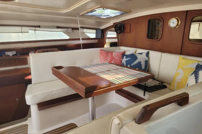 Slide: The Image of Interior of 2006 Gemini 105 MC sailboat with cozy seating and colorful cushions. - 22