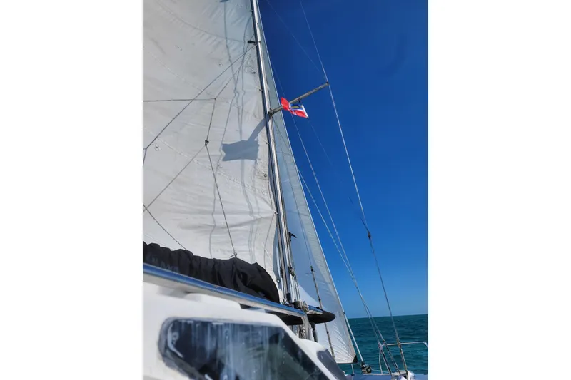 Slide: The Image of Sailing on a 2006 Gemini 105 MC catamaran under clear blue skies. - 23