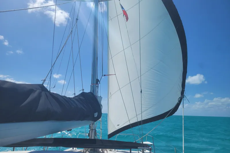 Slide: The Image of Sailing on a 2006 Gemini 105 MC catamaran under clear blue skies. - 24
