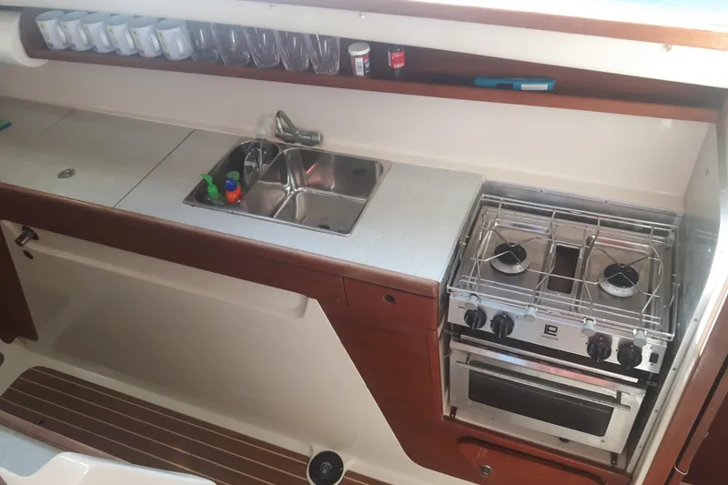 Slide: The Image of Compact kitchen in a 2006 Gemini 105 MC boat with stove, sink, and storage. - 4