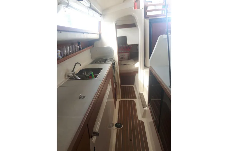 Slide: The Image of Interior of 2006 Gemini 105 MC sailboat, featuring a compact kitchen area. - 6