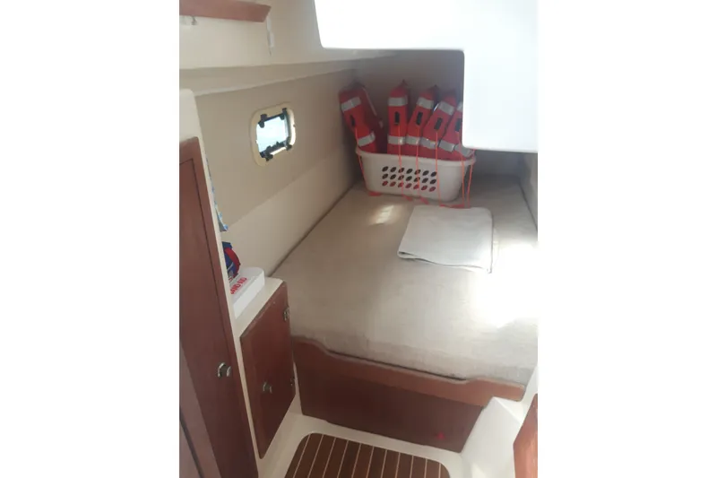 Slide: The Image of Interior cabin of 2006 Gemini 105 MC with bed and life jackets. - 7