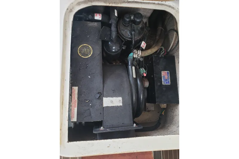 Slide: The Image of Engine compartment of a 2006 Gemini 105 MC sailboat, showing mechanical components. - 8