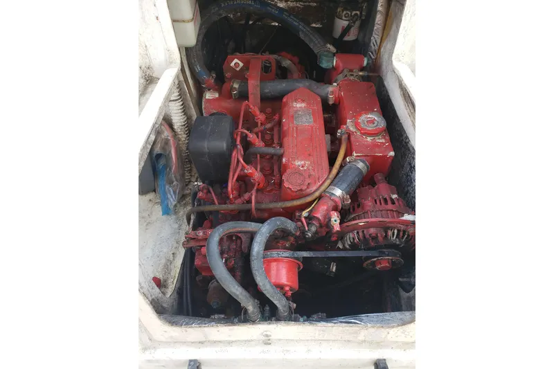 Slide: The Image of Engine compartment of a 2006 Gemini 105 MC sailboat, featuring a red marine engine. - 9