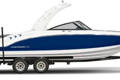 The Image of 2026 Chaparral 23 SSi OB boat, blue and white, on a trailer. - 1