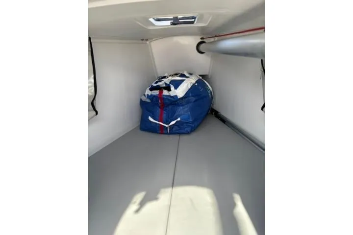 Slide: The Image of 2024 Beneteau First 27 interior storage with sail bag and hatch. - 13