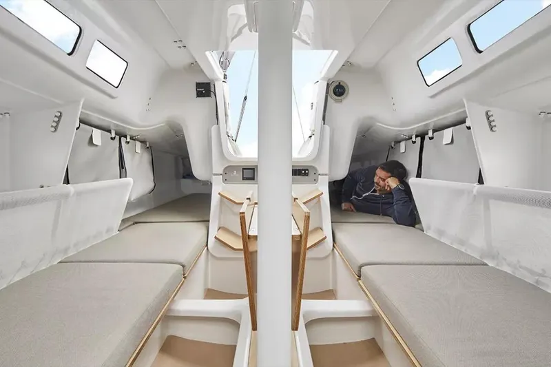 Slide: The Image of 2024 Beneteau First 27 interior cabin with modern design and comfortable seating. - 18