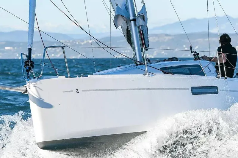 Slide: The Image of 2024 Beneteau First 27 sailboat navigating through waves on a sunny day. - 19