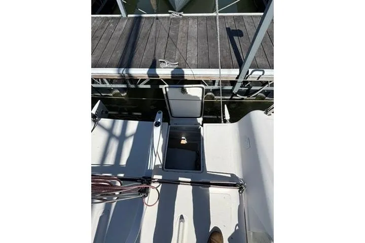 Slide: The Image of 2024 Beneteau First 27 sailboat deck view with open hatch at marina. - 5