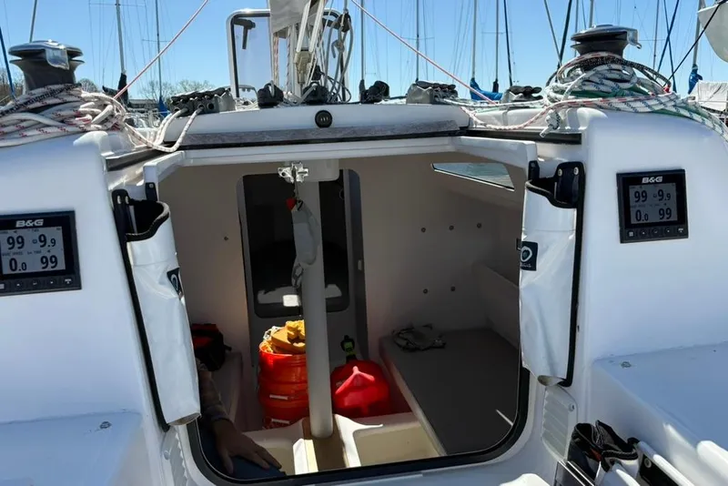 Slide: The Image of 2024 Beneteau First 27 sailboat cockpit with navigation instruments and cabin view. - 6