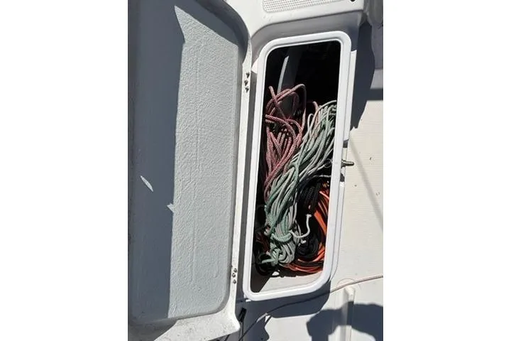Slide: The Image of Storage compartment with ropes on a 2024 Beneteau First 27 sailboat. - 7
