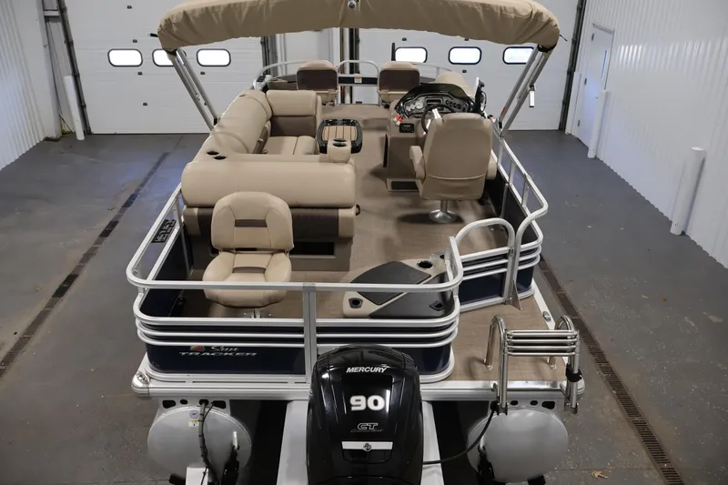 Slide: The Image of 2023 Sun Tracker Fishin' Barge 20 DLX pontoon boat in a garage setting. - 10