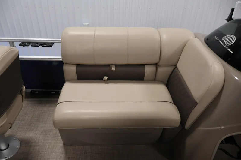 Slide: The Image of 2023 Sun Tracker Fishin' Barge 20 DLX, beige seating detail, indoor setting. - 20