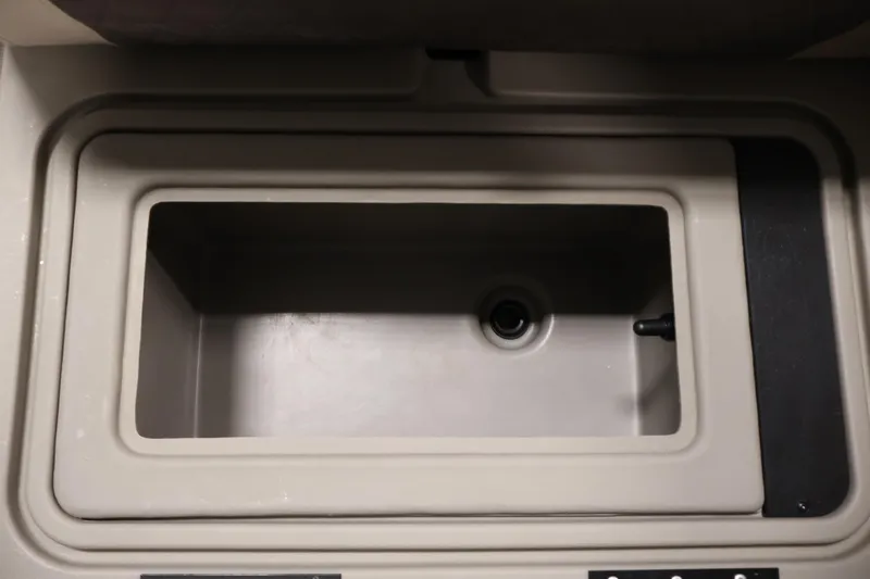 Slide: The Image of 2023 Sun Tracker Fishin' Barge 20 DLX livewell interior, beige color, rectangular shape. - 22