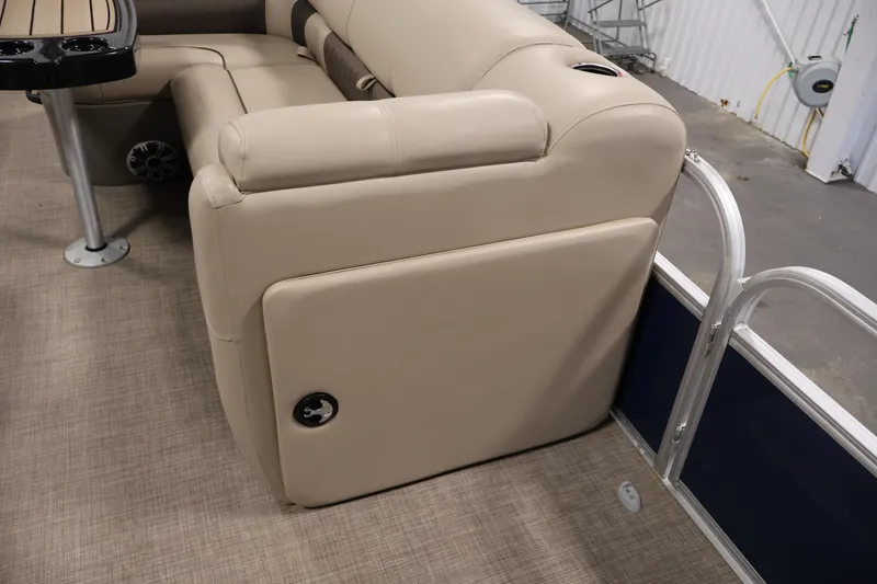 Slide: The Image of 2023 Sun Tracker Fishin' Barge 20 DLX interior with beige seating and table. - 23