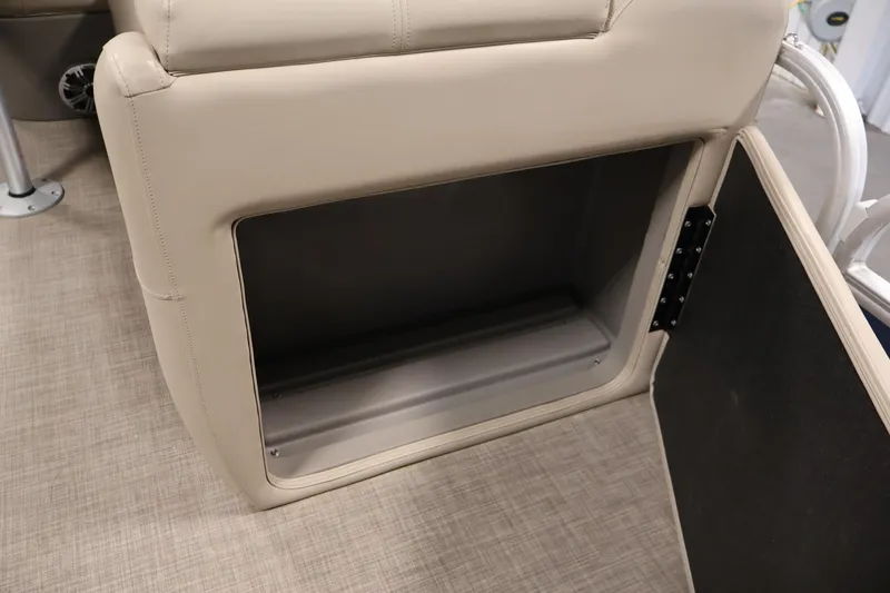 Slide: The Image of 2023 Sun Tracker Fishin' Barge 20 DLX storage compartment with beige upholstery. - 24