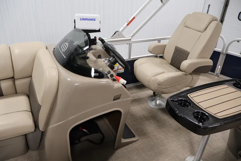 Slide: The Image of 2023 Sun Tracker Fishin' Barge 20 DLX interior with helm, seating, and table. - 25