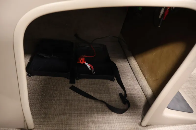 Slide: The Image of 2023 Sun Tracker Fishin' Barge 20 DLX interior storage compartment with equipment. - 26