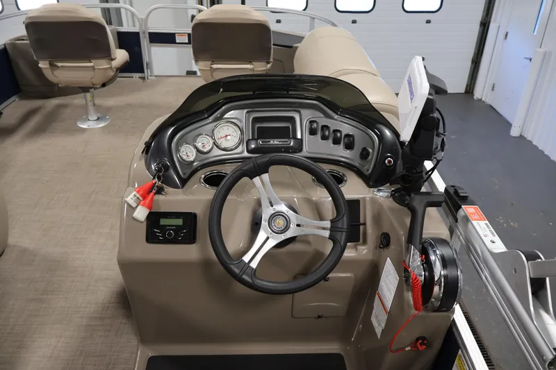 Slide: The Image of 2023 Sun Tracker Fishin' Barge 20 DLX dashboard with steering wheel and controls. - 27
