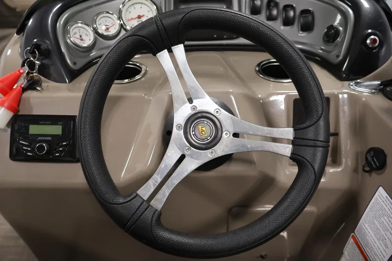 Slide: The Image of Steering wheel of 2023 Sun Tracker Fishin' Barge 20 DLX with dashboard controls. - 28