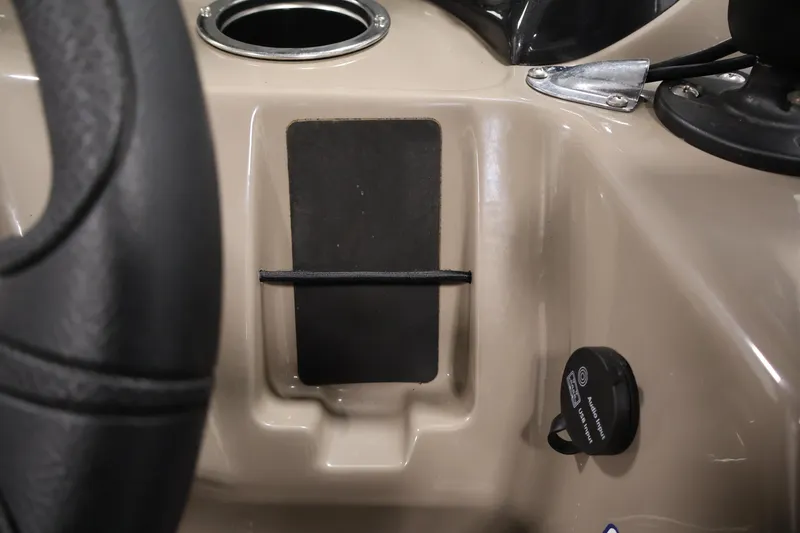Slide: The Image of 2023 Sun Tracker Fishin' Barge 20 DLX dashboard with cup holder and accessory port. - 31