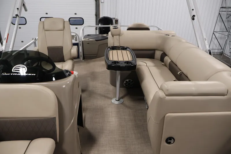 Slide: The Image of 2023 Sun Tracker Fishin' Barge 20 DLX interior with beige seating and table. - 37