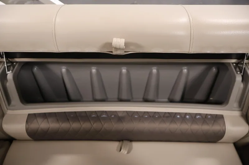 Slide: The Image of 2023 Sun Tracker Fishin' Barge 20 DLX seat storage compartment, beige and brown upholstery. - 38