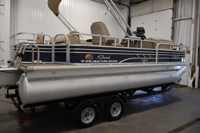Slide: The Image of 2023 Sun Tracker Fishin' Barge 20 DLX pontoon boat in indoor storage. - 4