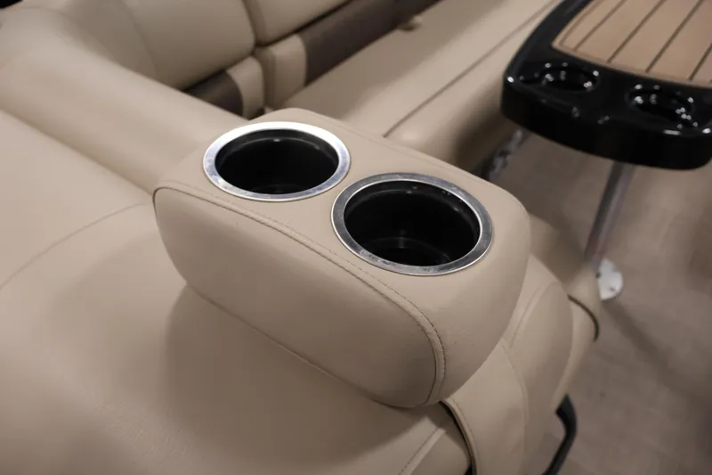 Slide: The Image of 2023 Sun Tracker Fishin' Barge 20 DLX interior with beige seating and cup holders. - 42