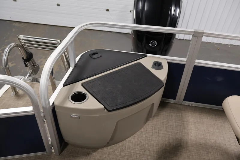 Slide: The Image of 2023 Sun Tracker Fishin' Barge 20 DLX interior with fishing station and cup holder. - 43