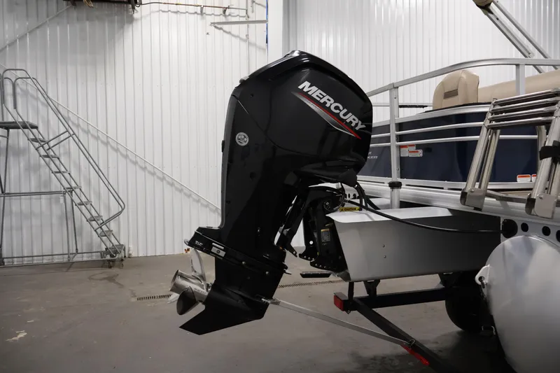 Slide: The Image of 2023 Sun Tracker Fishin' Barge 20 DLX with Mercury outboard motor in a garage. - 50