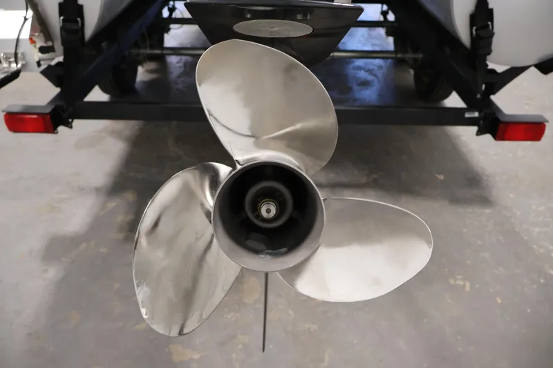 Slide: The Image of 2023 Sun Tracker Fishin' Barge 20 DLX propeller, close-up view in a garage setting. - 53