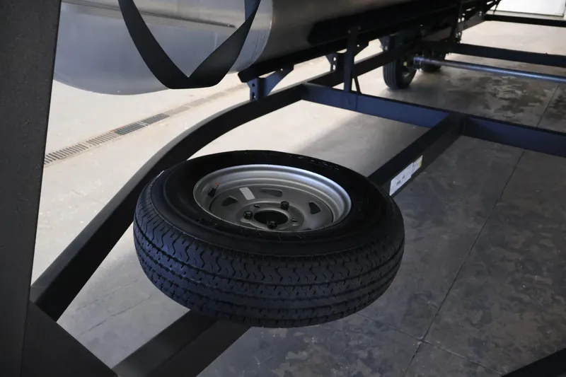 Slide: The Image of 2023 Sun Tracker Fishin' Barge 20 DLX trailer with spare tire mounted underneath. - 56