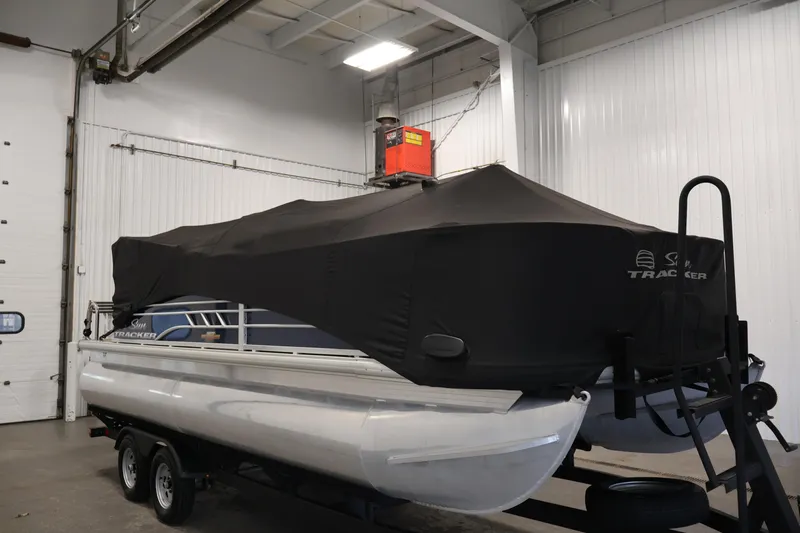 Slide: The Image of 2023 Sun Tracker Fishin' Barge 20 DLX covered in a garage setting. - 59
