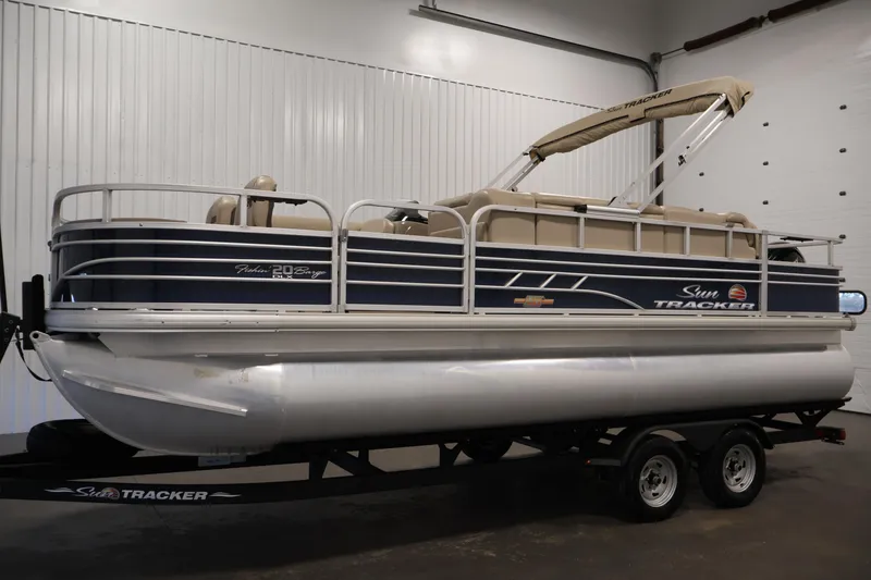 Slide: The Image of 2023 Sun Tracker Fishin' Barge 20 DLX pontoon boat in indoor showroom. - 8