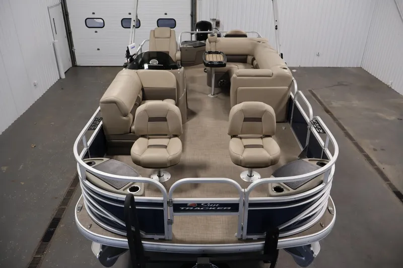 Slide: The Image of 2023 Sun Tracker Fishin' Barge 20 DLX pontoon boat with beige seating in a garage. - 9