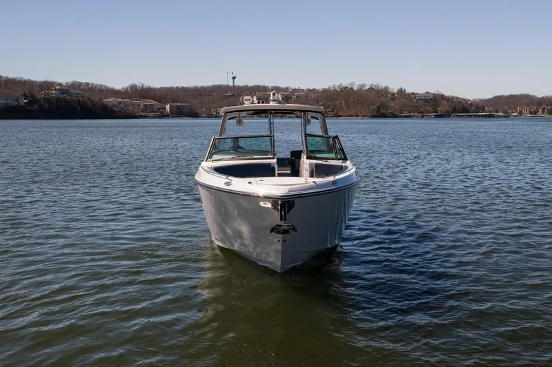 Slide: The Image of 2026 Monterey 378SS Super Sport boat on calm lake waters. - 12