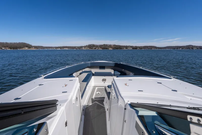 Slide: The Image of 2026 Monterey 378SS Super Sport boat on a serene lake under clear blue skies. - 18