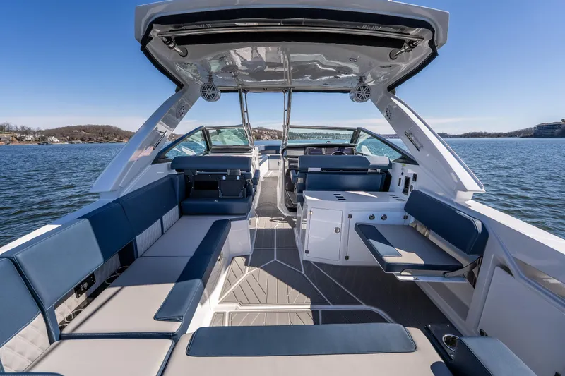 Slide: The Image of 2026 Monterey 378SS Super Sport boat interior with luxurious seating on a sunny lake. - 42